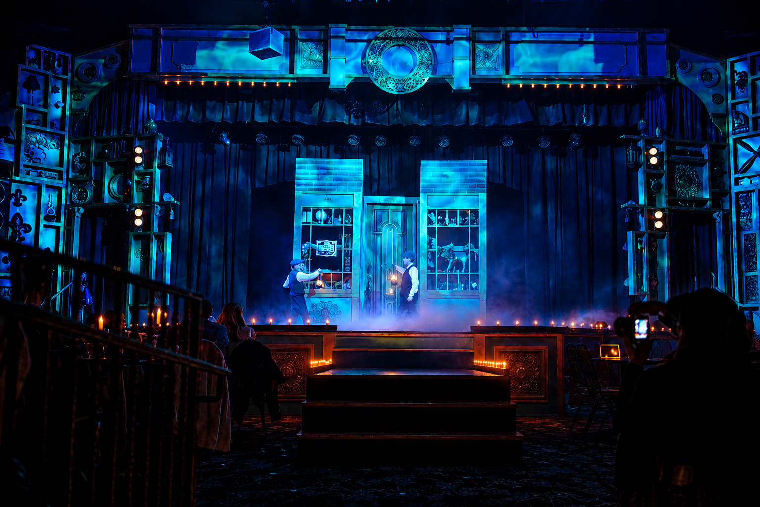 Stage with blue lighting, intricate set design, and performers in dramatic scene.