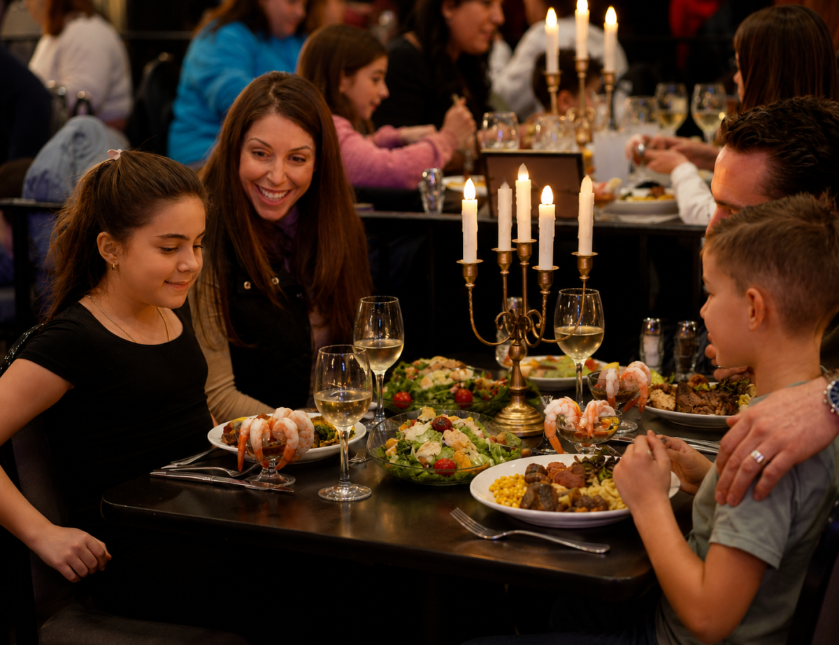 Family dining at a restaurant with seafood and salads on a candlelit table.