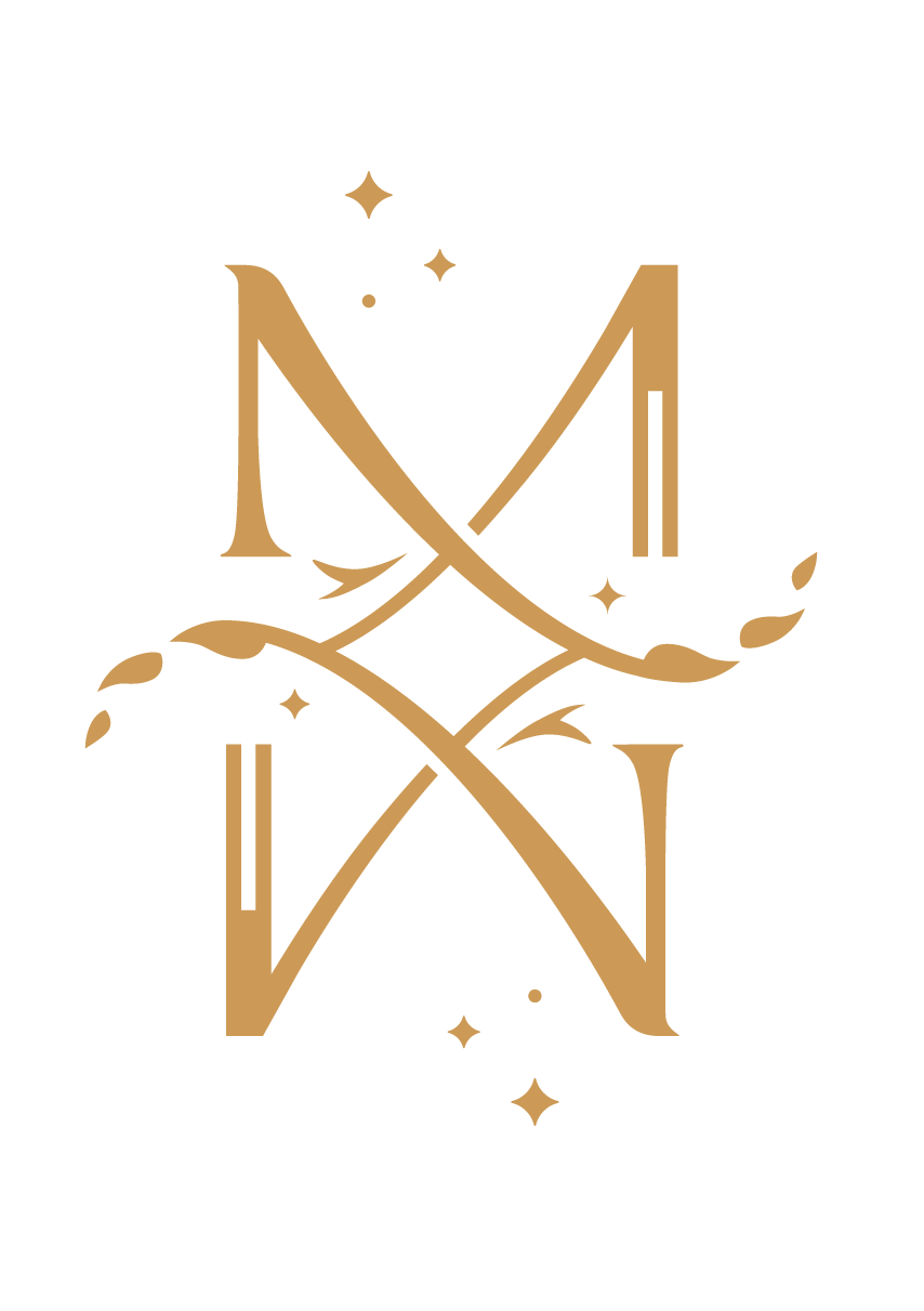 Ornate letter M design with stars and swirls on white background.