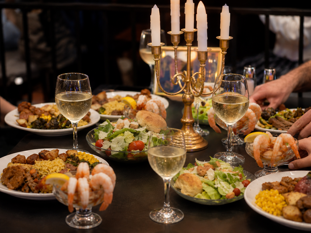 Dinner table with wine, shrimp cocktails, and assorted dishes.